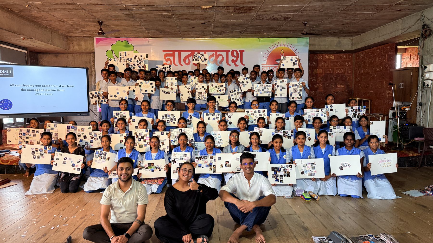 Students at Dnyan Prakash School holding up their finished vision boards, with the facilitators seated in front