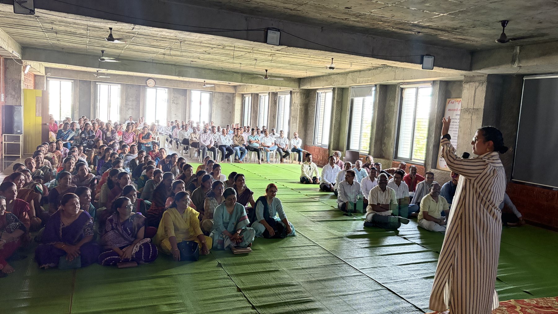 A packed room of parents at Dnyan Prakash School, listening to a facilitator during the parent session